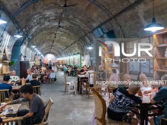 Residents are drinking tea at an old teahouse in a bomb shelter as the high temperature continues in Chongqing, China, on July 21, 2024. (