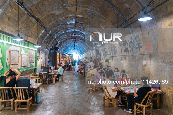 Residents are drinking tea at an old teahouse in a bomb shelter as the high temperature continues in Chongqing, China, on July 21, 2024. 