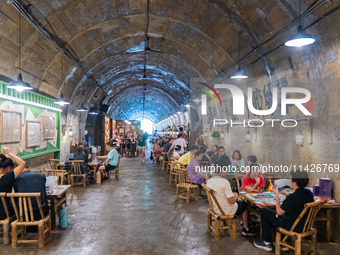 Residents are drinking tea at an old teahouse in a bomb shelter as the high temperature continues in Chongqing, China, on July 21, 2024. (