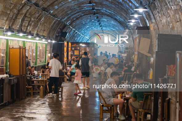 Residents are drinking tea at an old teahouse in a bomb shelter as the high temperature continues in Chongqing, China, on July 21, 2024. 