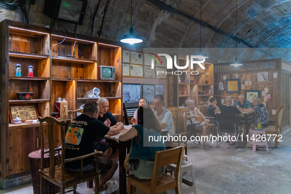 Residents are drinking tea at an old teahouse in a bomb shelter as the high temperature continues in Chongqing, China, on July 21, 2024. 