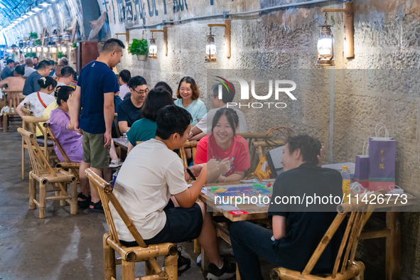 Residents are drinking tea at an old teahouse in a bomb shelter as the high temperature continues in Chongqing, China, on July 21, 2024. 