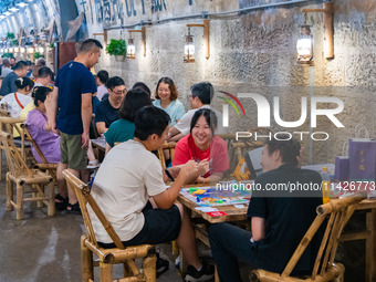 Residents are drinking tea at an old teahouse in a bomb shelter as the high temperature continues in Chongqing, China, on July 21, 2024. (