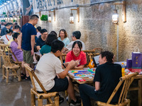 Residents are drinking tea at an old teahouse in a bomb shelter as the high temperature continues in Chongqing, China, on July 21, 2024. (