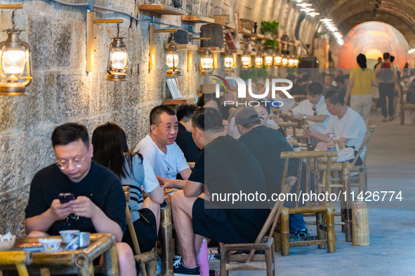 Residents are drinking tea at an old teahouse in a bomb shelter as the high temperature continues in Chongqing, China, on July 21, 2024. 