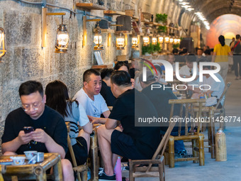 Residents are drinking tea at an old teahouse in a bomb shelter as the high temperature continues in Chongqing, China, on July 21, 2024. (