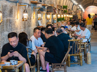 Residents are drinking tea at an old teahouse in a bomb shelter as the high temperature continues in Chongqing, China, on July 21, 2024. (