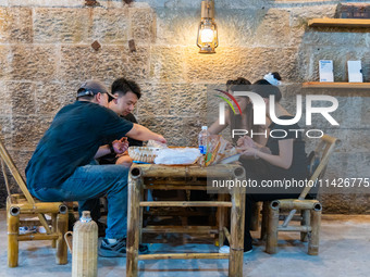 Residents are drinking tea at an old teahouse in a bomb shelter as the high temperature continues in Chongqing, China, on July 21, 2024. (