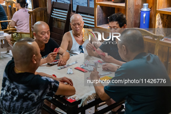 Residents are drinking tea at an old teahouse in a bomb shelter as the high temperature continues in Chongqing, China, on July 21, 2024. 