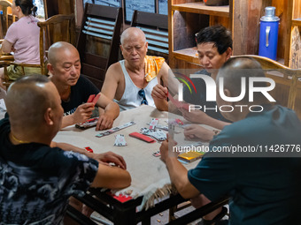 Residents are drinking tea at an old teahouse in a bomb shelter as the high temperature continues in Chongqing, China, on July 21, 2024. (