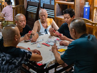 Residents are drinking tea at an old teahouse in a bomb shelter as the high temperature continues in Chongqing, China, on July 21, 2024. (