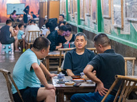 Residents are drinking tea at an old teahouse in a bomb shelter as the high temperature continues in Chongqing, China, on July 21, 2024. (