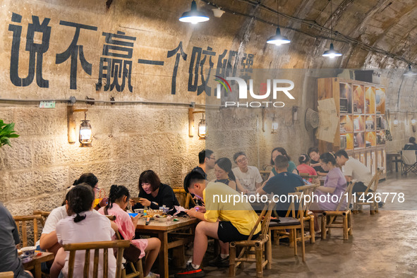 Residents are drinking tea at an old teahouse in a bomb shelter as the high temperature continues in Chongqing, China, on July 21, 2024. 