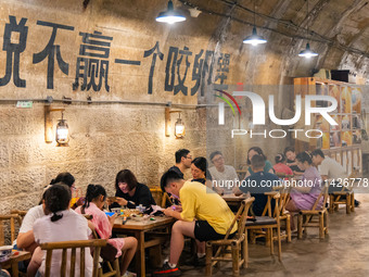 Residents are drinking tea at an old teahouse in a bomb shelter as the high temperature continues in Chongqing, China, on July 21, 2024. (