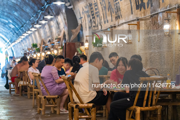 Residents are drinking tea at an old teahouse in a bomb shelter as the high temperature continues in Chongqing, China, on July 21, 2024. 