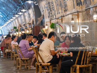 Residents are drinking tea at an old teahouse in a bomb shelter as the high temperature continues in Chongqing, China, on July 21, 2024. (