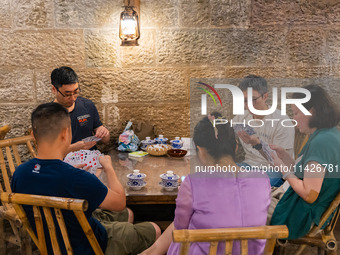 Residents are drinking tea at an old teahouse in a bomb shelter as the high temperature continues in Chongqing, China, on July 21, 2024. (