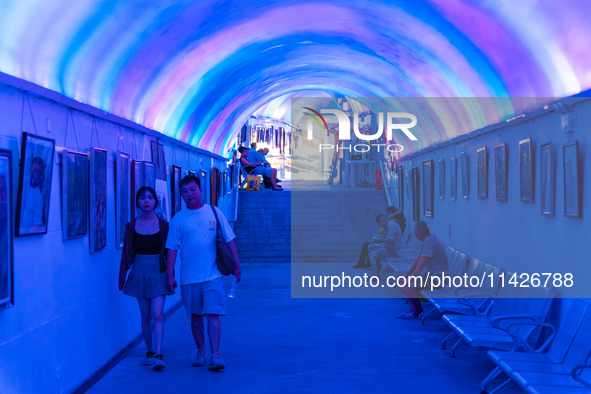 Citizens are cooling off in a bomb shelter as the high temperature continues in Chongqing, China, on July 21, 2024. 