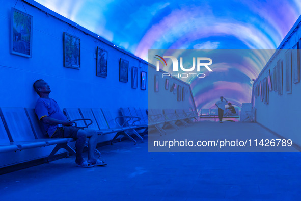 Citizens are cooling off in a bomb shelter as the high temperature continues in Chongqing, China, on July 21, 2024. 