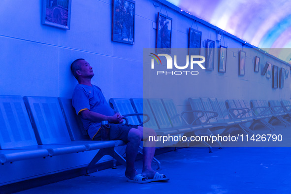 Citizens are cooling off in a bomb shelter as the high temperature continues in Chongqing, China, on July 21, 2024. 