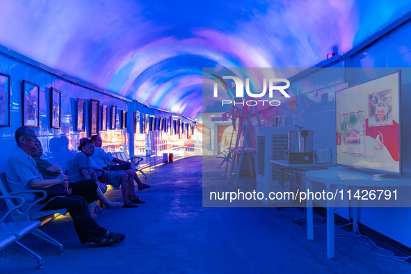 Citizens are cooling off in a bomb shelter as the high temperature continues in Chongqing, China, on July 21, 2024. 