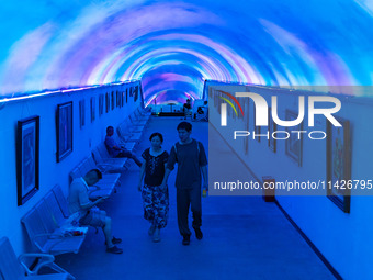 Citizens are cooling off in a bomb shelter as the high temperature continues in Chongqing, China, on July 21, 2024. (