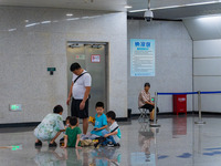 Citizens are cooling off at a rail transit platform as the high temperature continues in Chongqing, China, on July 21, 2024. (