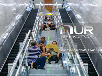 Citizens are cooling off at a rail transit platform as the high temperature continues in Chongqing, China, on July 21, 2024. (