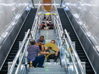 Citizens are cooling off at a rail transit platform as the high temperature continues in Chongqing, China, on July 21, 2024. (