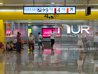 Citizens are cooling off at a rail transit platform as the high temperature continues in Chongqing, China, on July 21, 2024. (