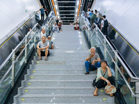 Citizens are cooling off at a rail transit platform as the high temperature continues in Chongqing, China, on July 21, 2024. (