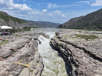 Tourists are visiting Hukou Waterfall on the Yellow River at the junction of Yichuan county and Ji county in North China's Shaanxi province,...