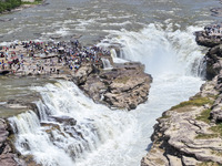 Tourists are visiting Hukou Waterfall on the Yellow River at the junction of Yichuan county and Ji county in North China's Shaanxi province,...