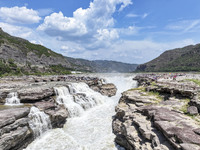 Tourists are visiting Hukou Waterfall on the Yellow River at the junction of Yichuan county and Ji county in North China's Shaanxi province,...