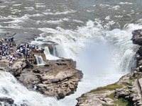 Tourists are visiting Hukou Waterfall on the Yellow River at the junction of Yichuan county and Ji county in North China's Shaanxi province,...