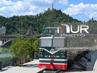 Students are reading in a green lacquered ''train book house'' in Yuping county, Guizhou province, China, on July 21, 2024. (