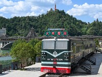 Students are reading in a green lacquered ''train book house'' in Yuping county, Guizhou province, China, on July 21, 2024. (