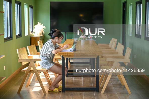 Students are reading in a green lacquered ''train book house'' in Yuping county, Guizhou province, China, on July 21, 2024. 