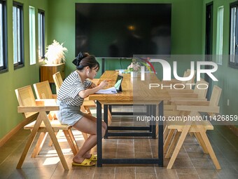 Students are reading in a green lacquered ''train book house'' in Yuping county, Guizhou province, China, on July 21, 2024. (