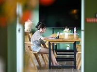 Students are reading in a green lacquered ''train book house'' in Yuping county, Guizhou province, China, on July 21, 2024. (