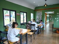 Students are reading in a green lacquered ''train book house'' in Yuping county, Guizhou province, China, on July 21, 2024. (