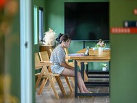 Students are reading in a green lacquered ''train book house'' in Yuping county, Guizhou province, China, on July 21, 2024. (