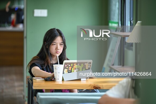 Students are reading in a green lacquered ''train book house'' in Yuping county, Guizhou province, China, on July 21, 2024. 