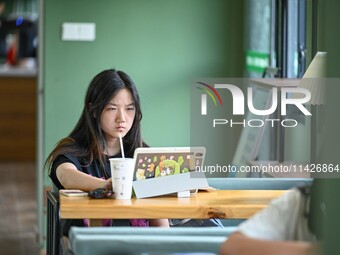 Students are reading in a green lacquered ''train book house'' in Yuping county, Guizhou province, China, on July 21, 2024. (