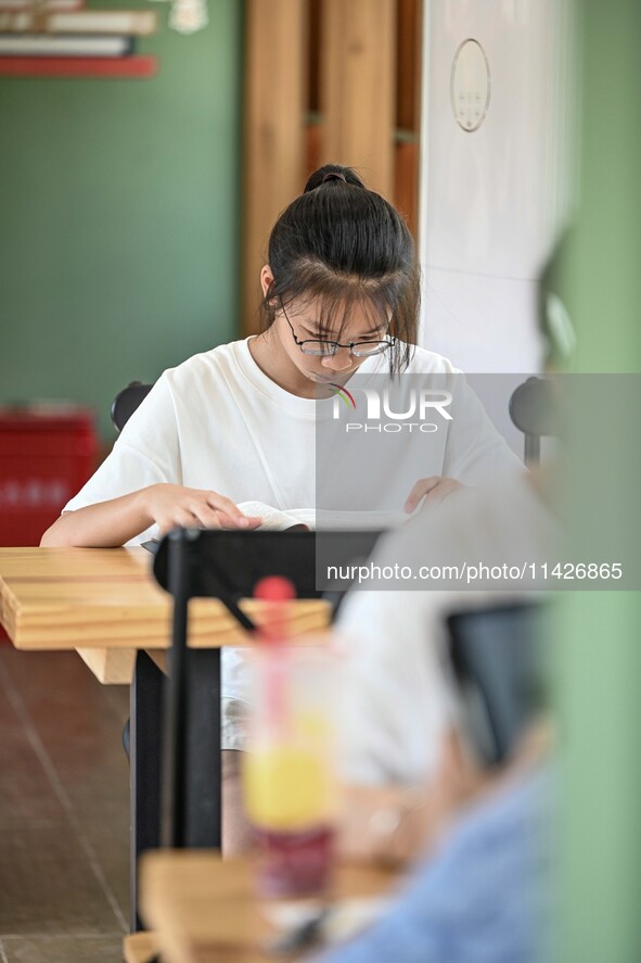 Students are reading in a green lacquered ''train book house'' in Yuping county, Guizhou province, China, on July 21, 2024. 