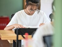 Students are reading in a green lacquered ''train book house'' in Yuping county, Guizhou province, China, on July 21, 2024. (