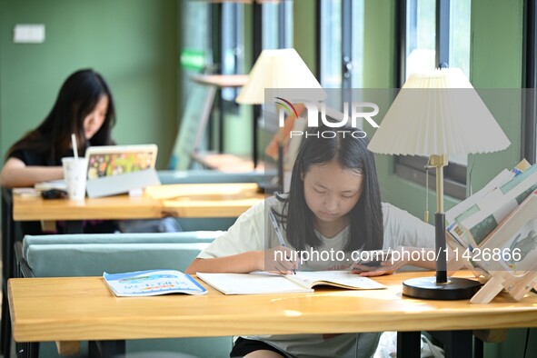 Students are reading in a green lacquered ''train book house'' in Yuping county, Guizhou province, China, on July 21, 2024. 