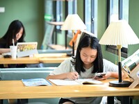 Students are reading in a green lacquered ''train book house'' in Yuping county, Guizhou province, China, on July 21, 2024. (