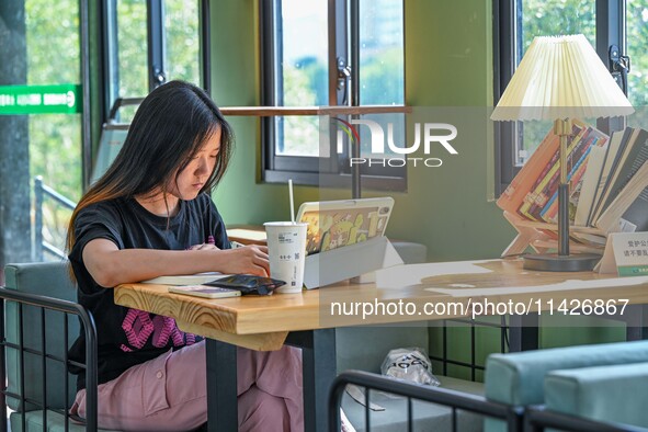 Students are reading in a green lacquered ''train book house'' in Yuping county, Guizhou province, China, on July 21, 2024. 