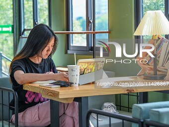 Students are reading in a green lacquered ''train book house'' in Yuping county, Guizhou province, China, on July 21, 2024. (